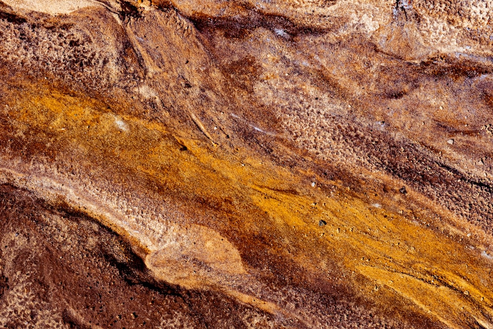 a close up of a rock with a yellow substance on it