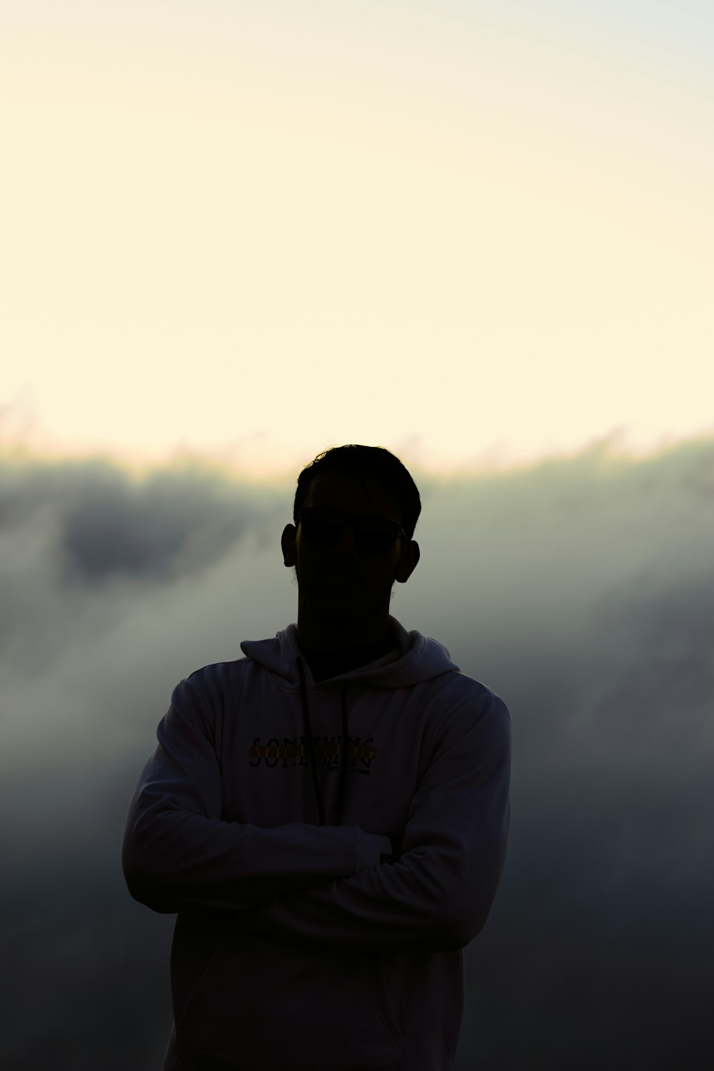 a man standing in front of a foggy sky