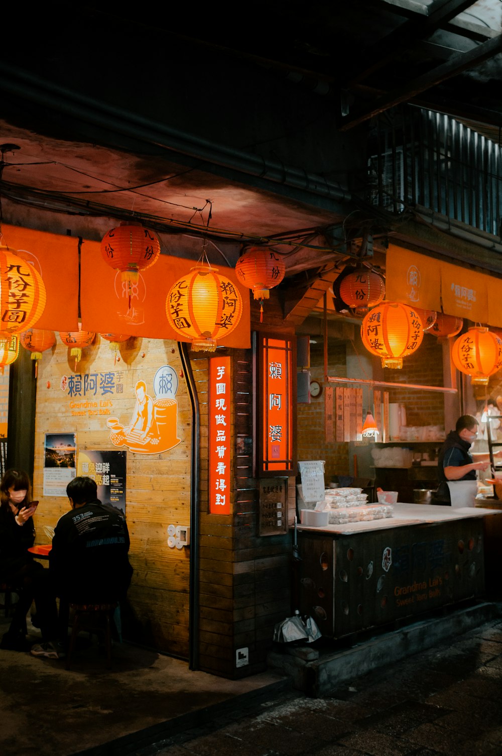 a restaurant with orange lanterns hanging from the ceiling
