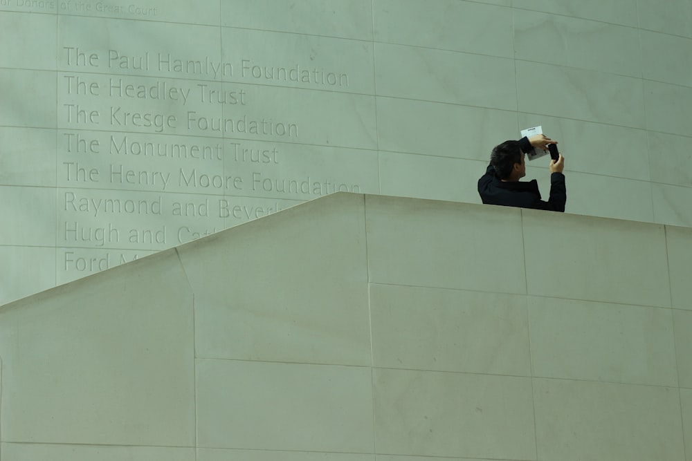 a man taking a picture of a wall with a camera