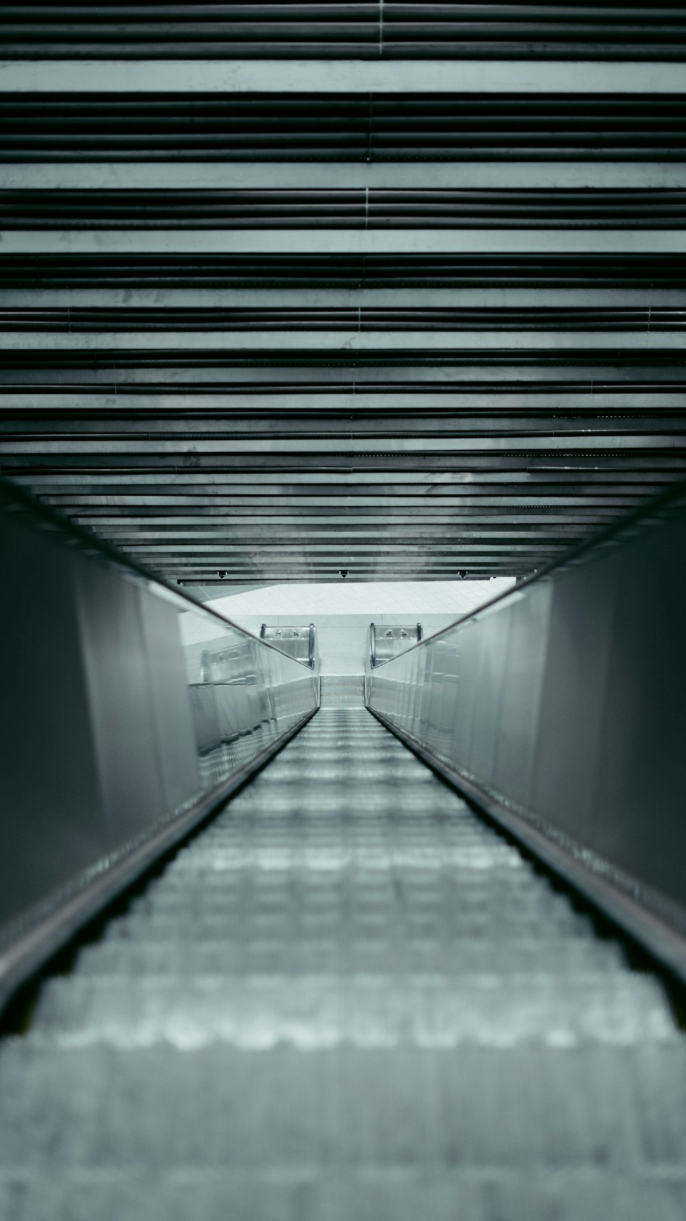 a long walkway with a train going through it