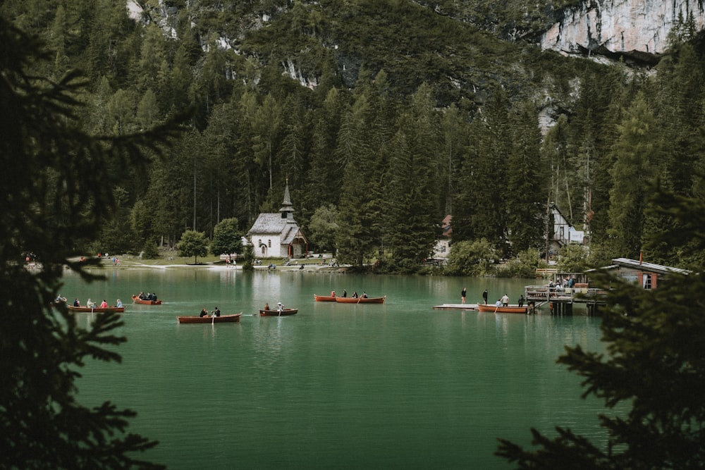 a group of people in canoes on a lake