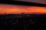 The silhouette of Niamey’s skyline with minarets and modern buildings at dusk.