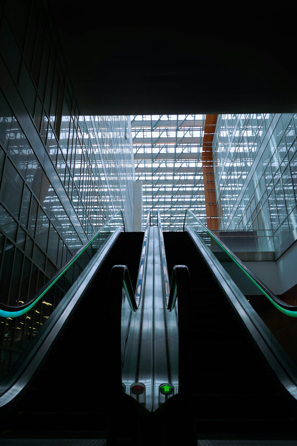 an escalator in a building with glass walls