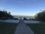 Spacious open-air wedding venue under a clear blue sky with stylish seating