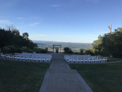 Spacious open-air wedding venue under a clear blue sky with stylish seating