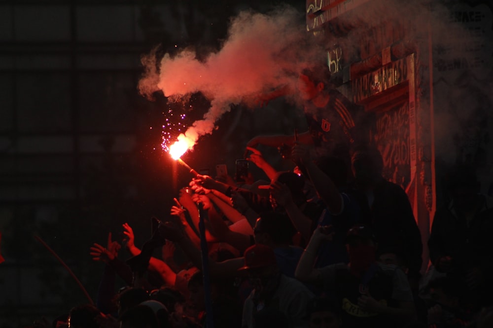 a crowd of people watching a fireworks show