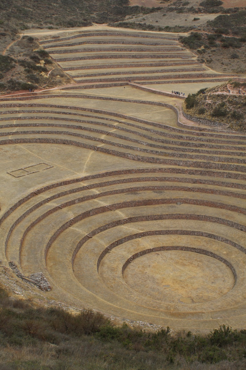 a large circular structure in the middle of a field