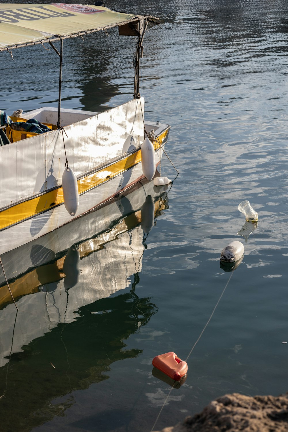 ein gelb-weißes Boot in einem Gewässer