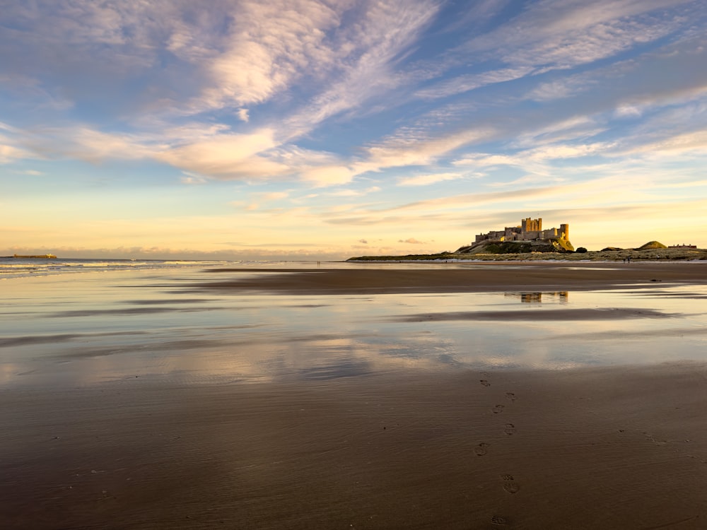 a view of a beach with a building in the distance