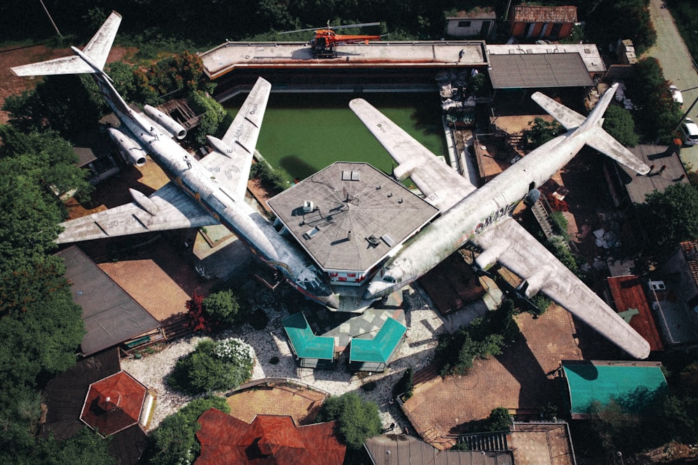 an aerial view of a large airplane parked in front of a building