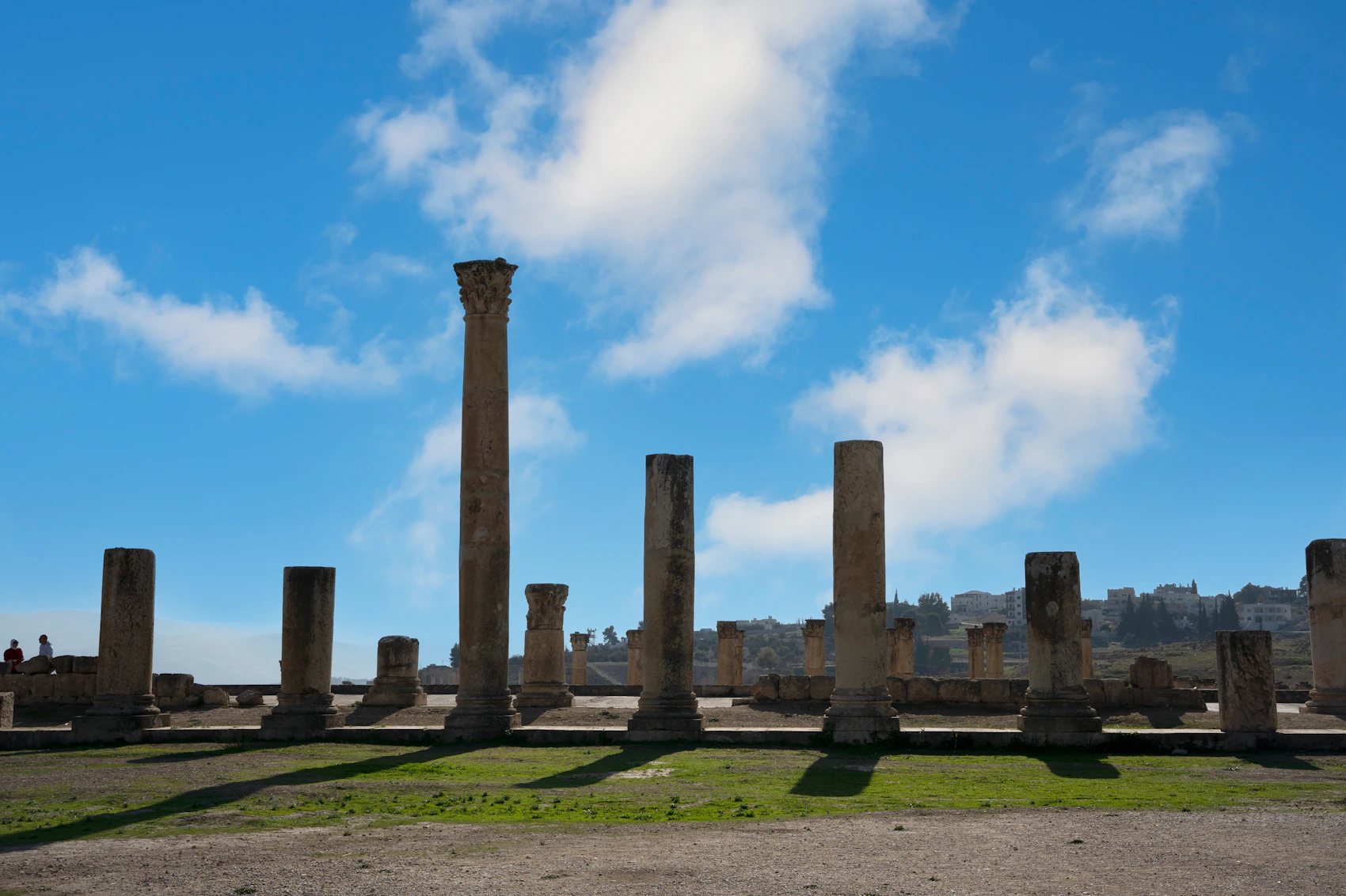 Ancient columns standing beneath a blue sky at Jerash in Jordan