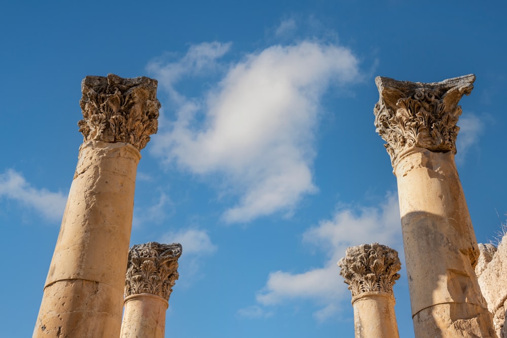 a group of columns with a sky in the background