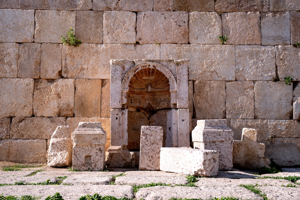 a stone wall with a doorway in the middle of it