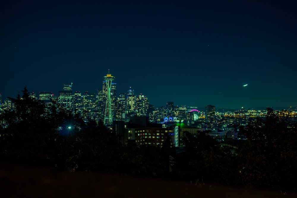 a view of a city at night from a hill