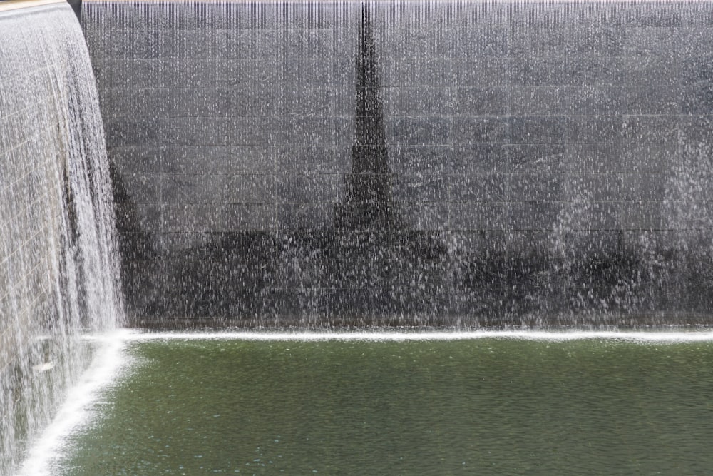 a man standing in front of a waterfall