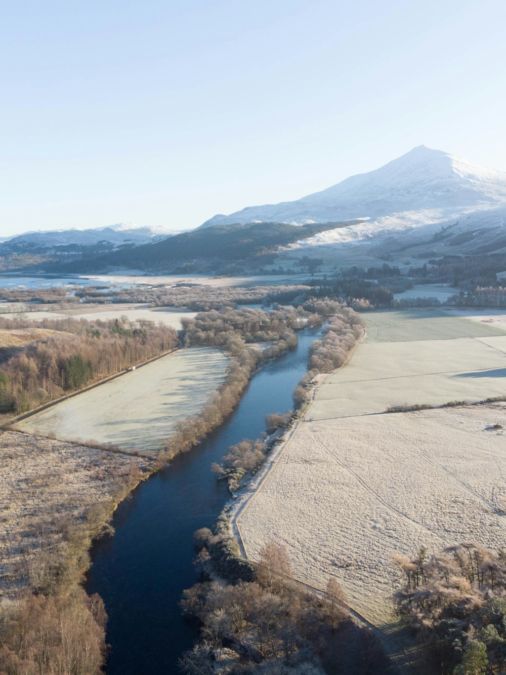 a river running through a snow covered field