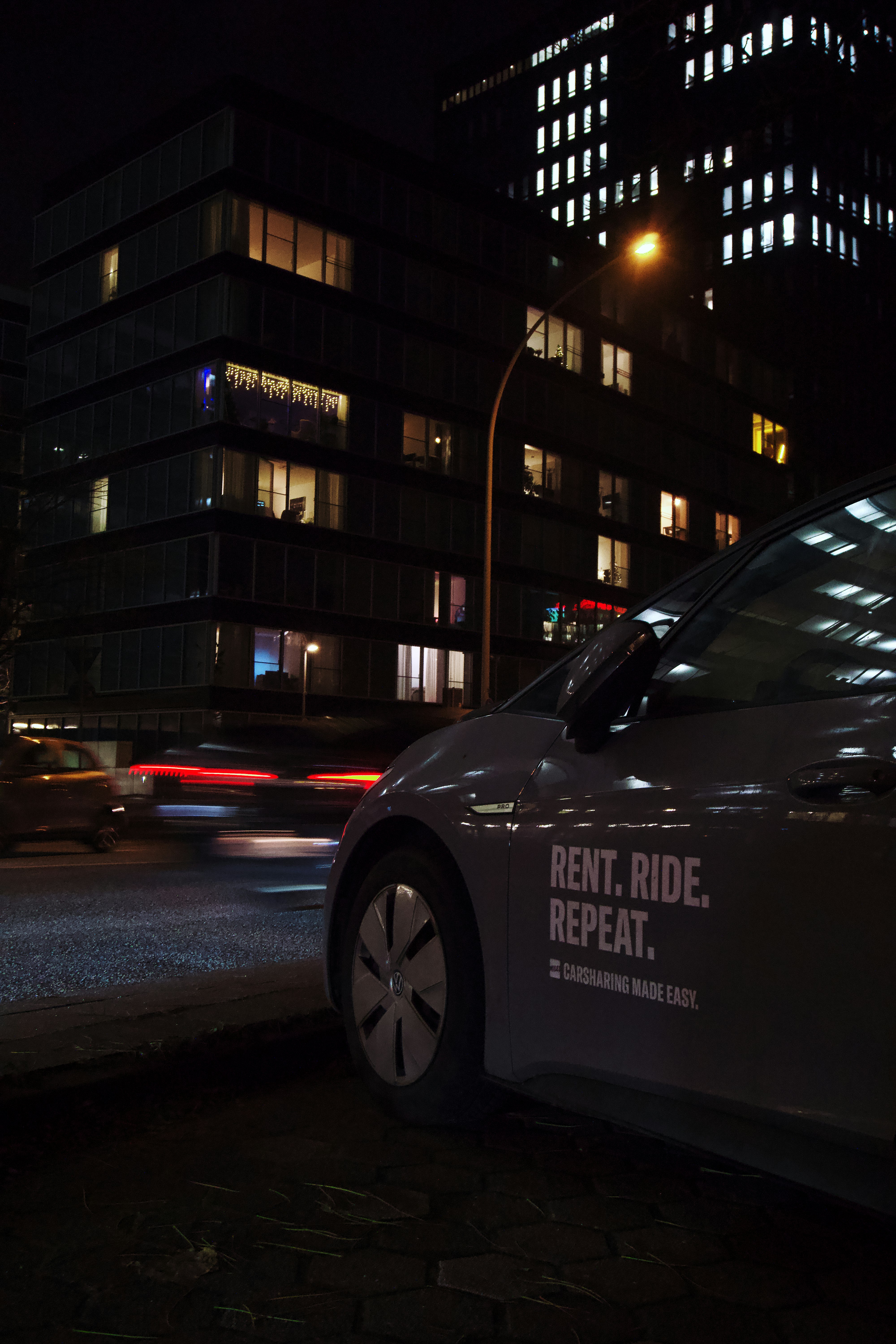 a car parked on the side of the road at night