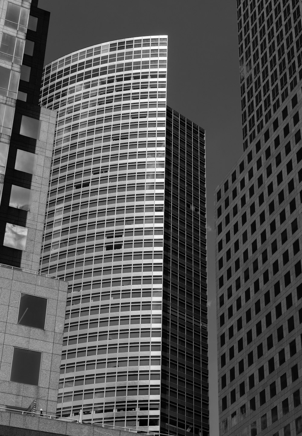 a black and white photo of some very tall buildings