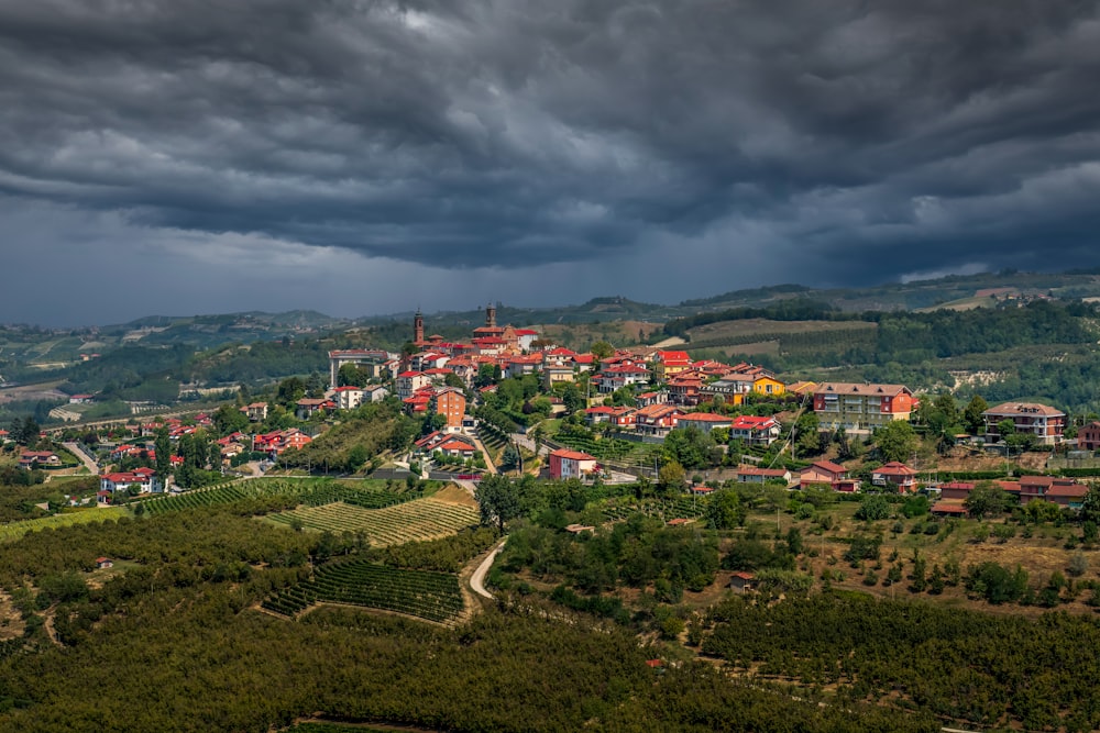 a village on a hill under a cloudy sky