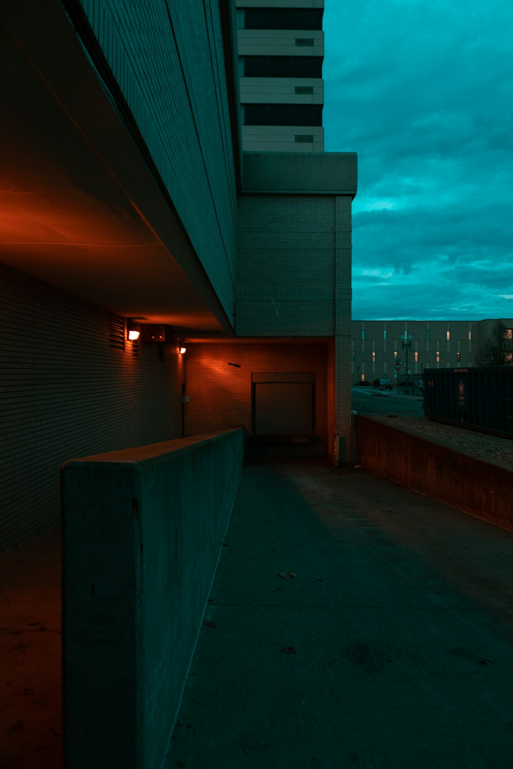 an empty parking garage with a dark sky in the background