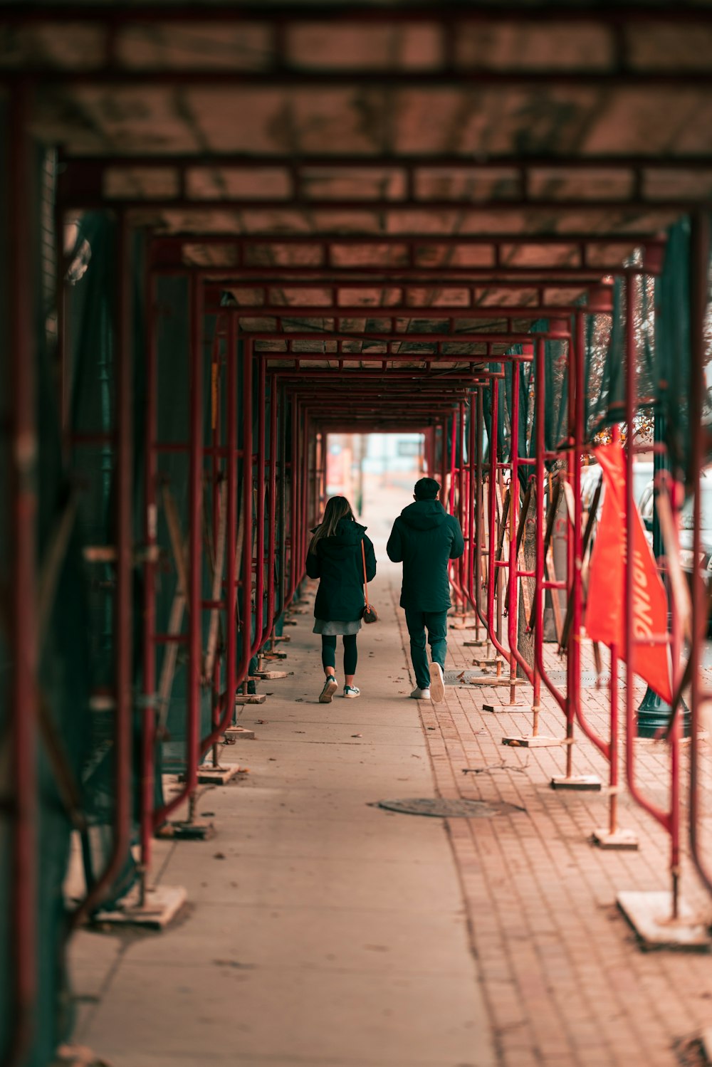 a couple of people that are walking down a sidewalk