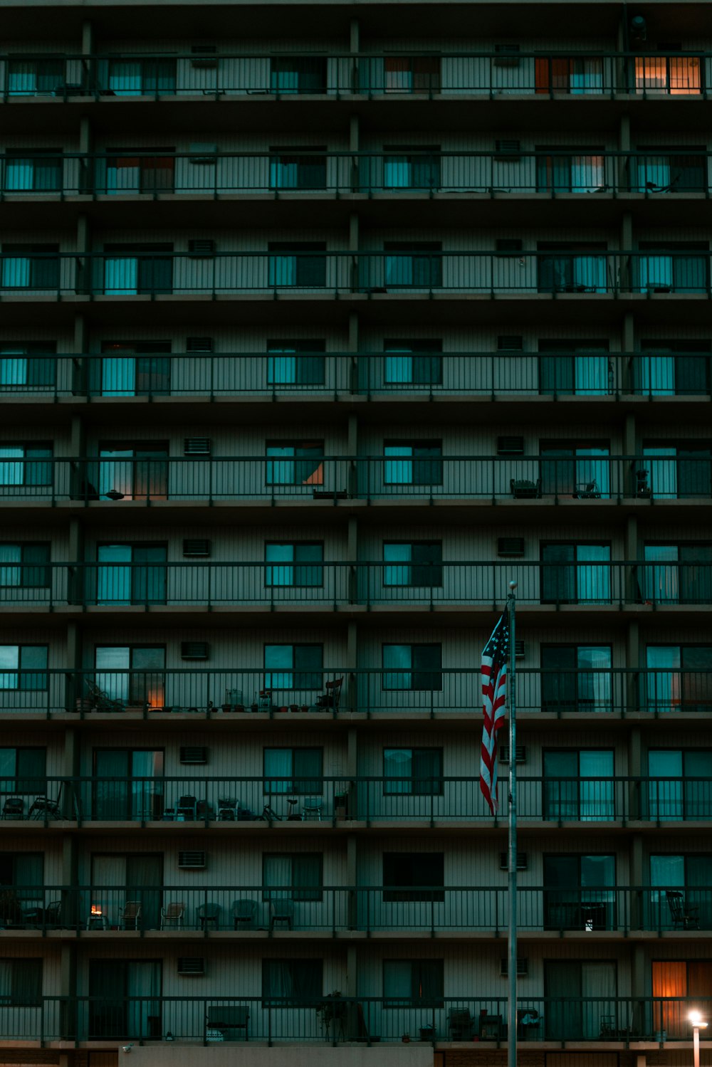 a tall building with a flag in front of it