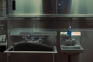 a stainless steel kitchen with a sink and oven