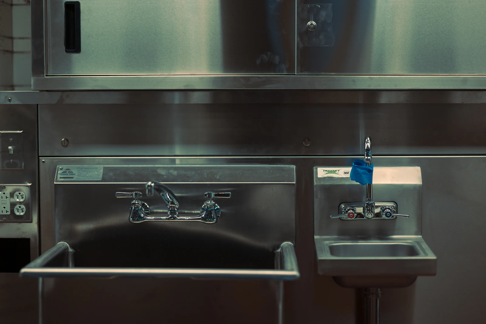 Stainless-steel sink and surfaces in a commercial kitchen wash-up area