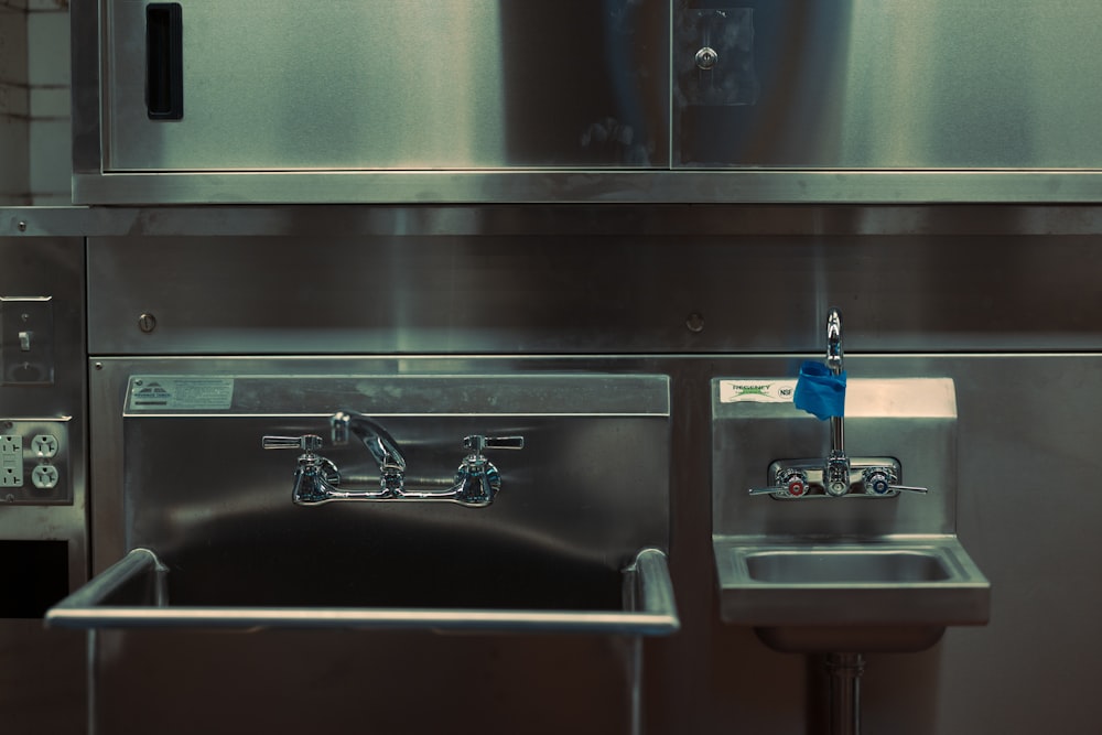 a stainless steel kitchen with a sink and oven