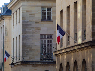 a building with two flags flying in front of it