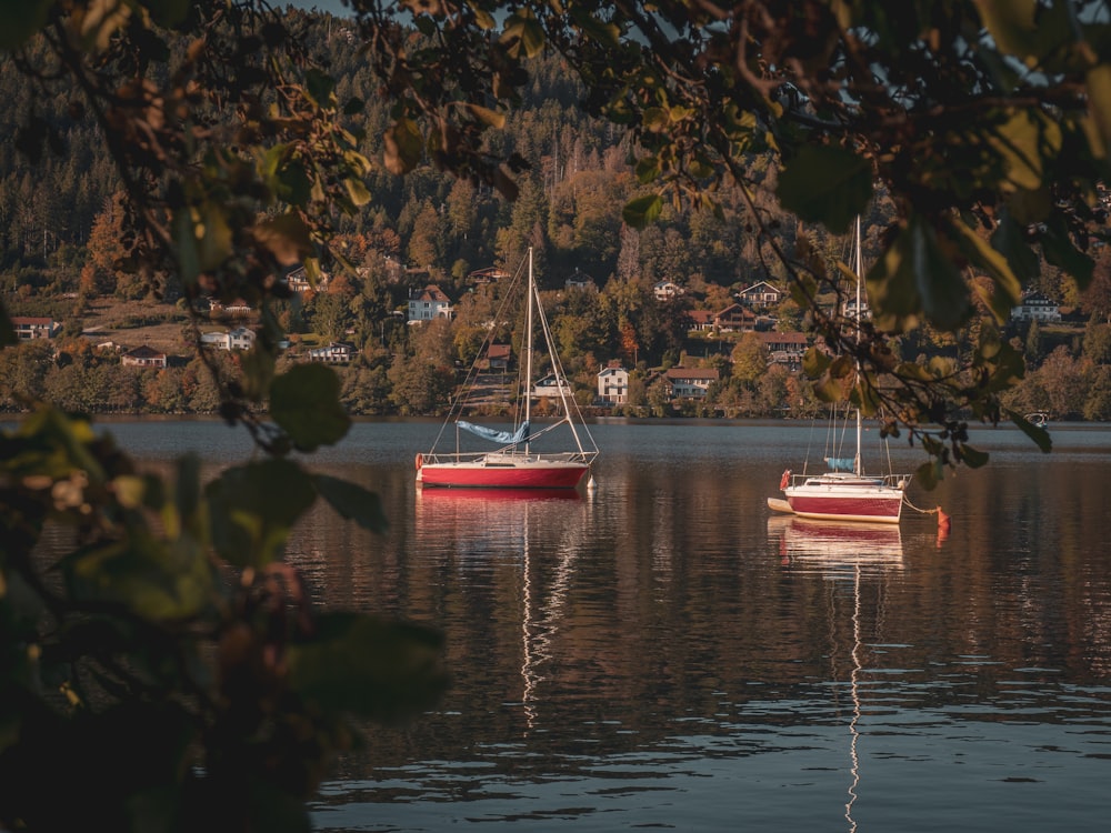 a couple of boats floating on top of a lake