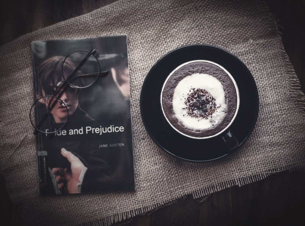 a cup of coffee and a book on a table