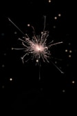 A close-up of a sparkling jvv cracker lit during a festival.