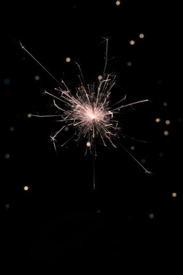 A close-up of a sparkling jvv cracker lit during a festival.