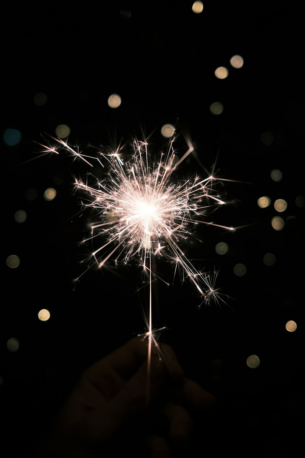 a person holding a sparkler in their hand