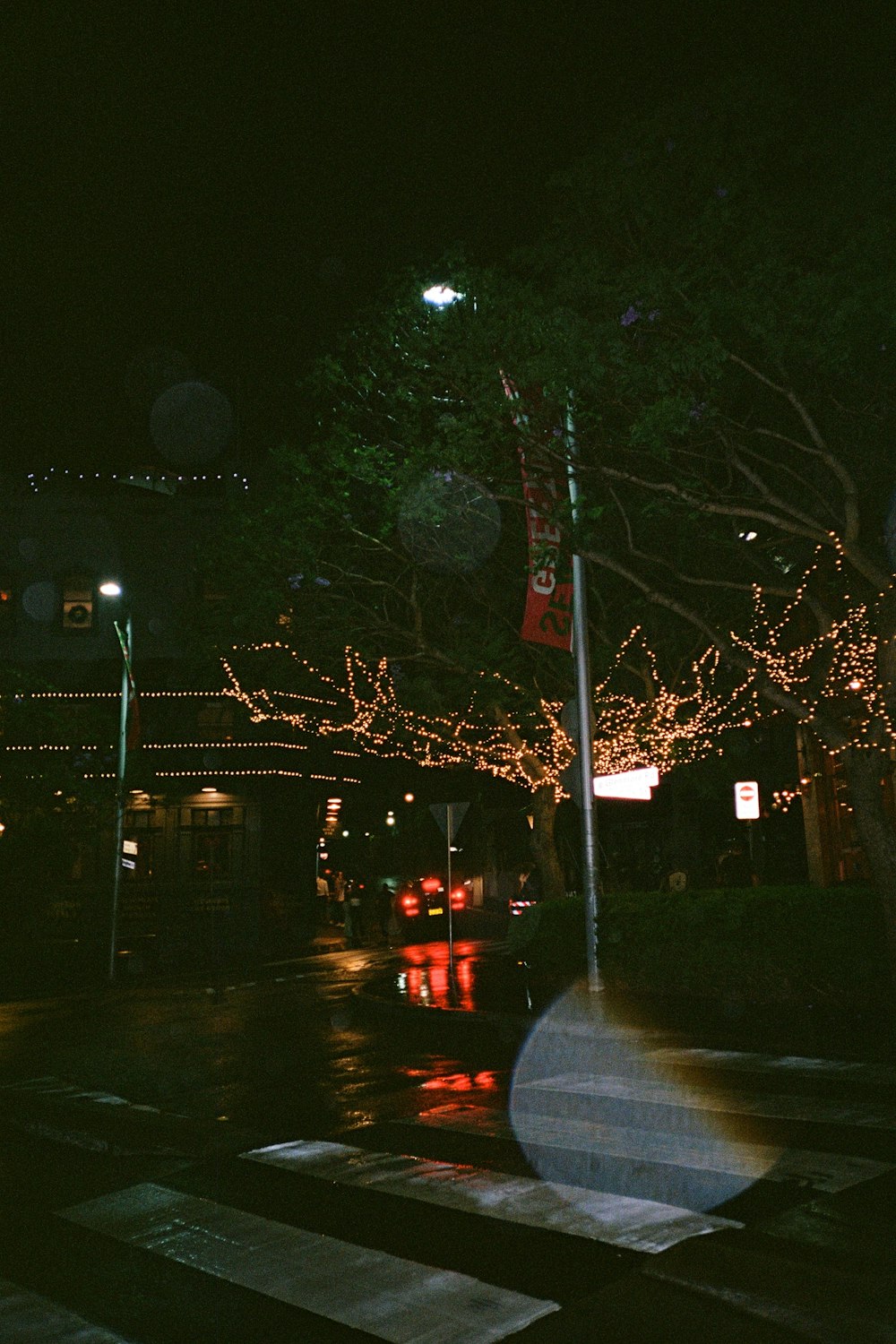 a city street at night with christmas lights