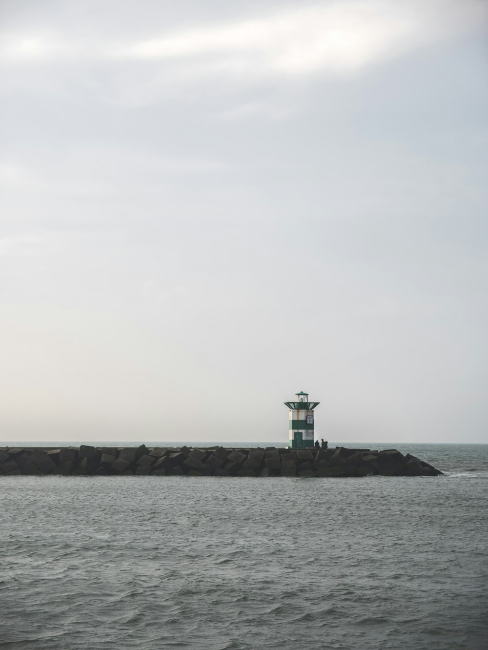 a light house sitting on top of a small island