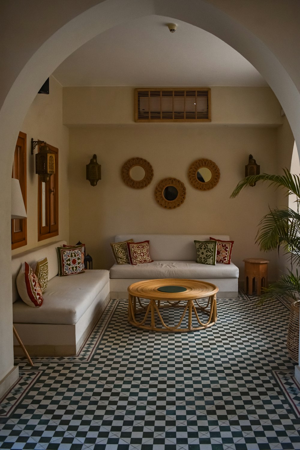 a living room with a checkered floor and a couch