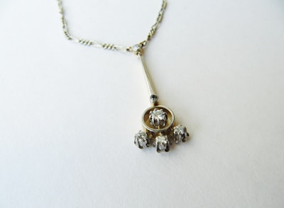 a silver necklace with a bunch of beads hanging from it