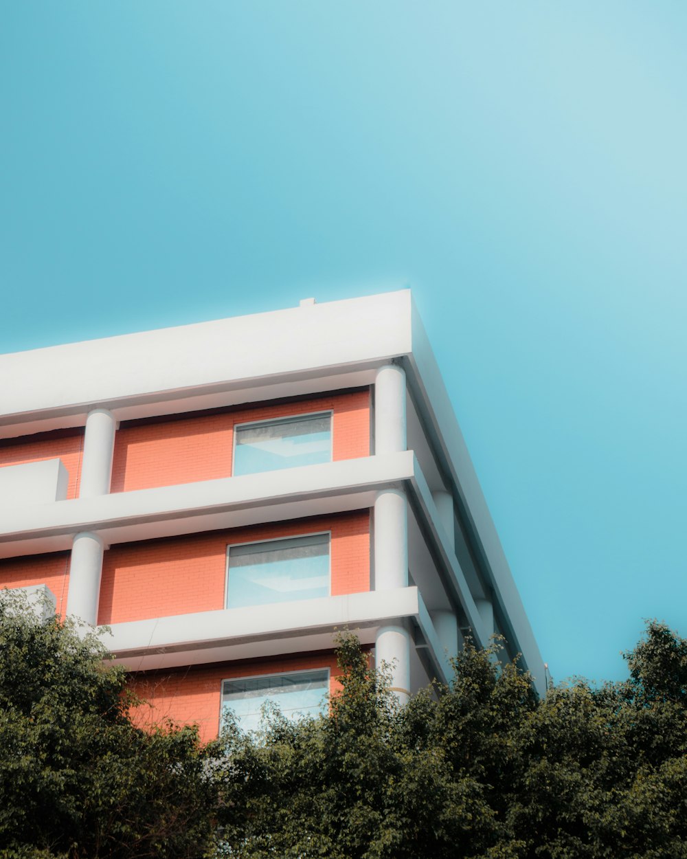 a red and white building with trees in front of it