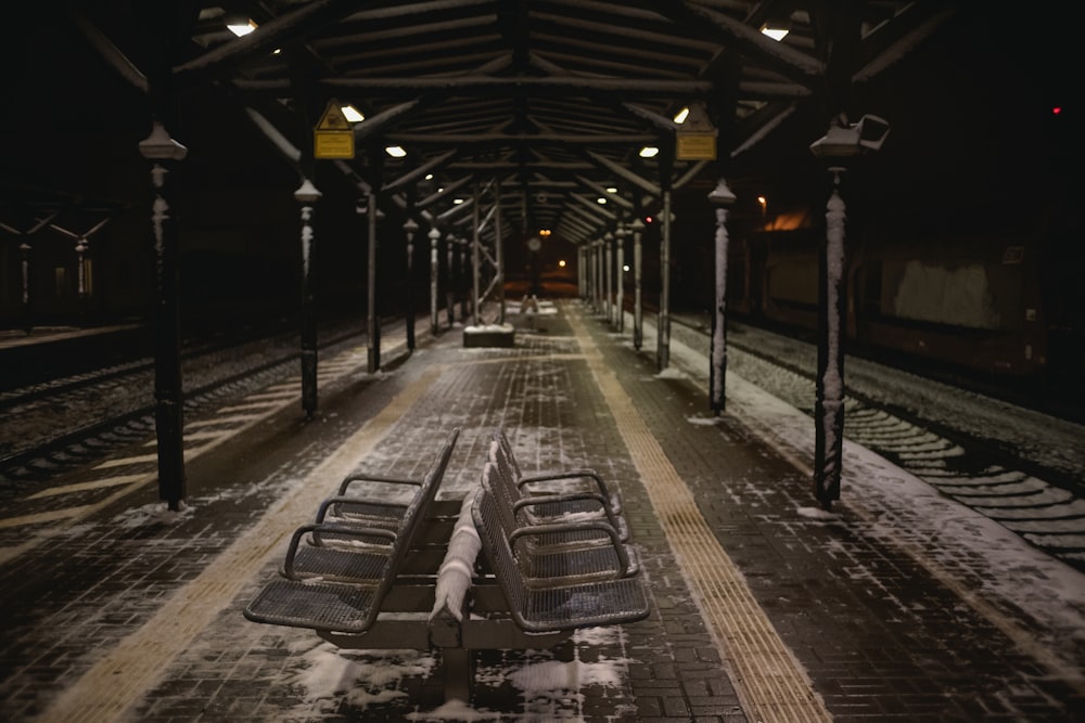 une gare avec des bancs couverts de neige