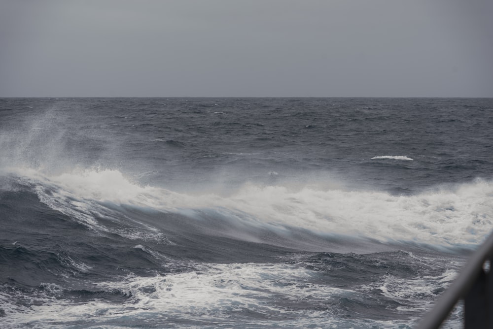 a large body of water with a wave coming in