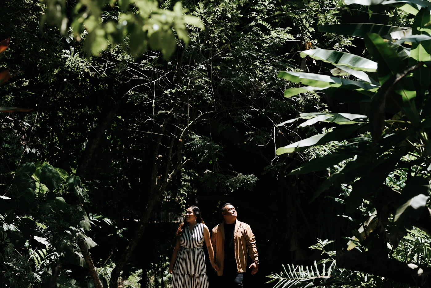 Couple at a remote beach accessible only by boat near Nuqui Colombia with the Pacific ocean and the undisturbed rainforest all around them