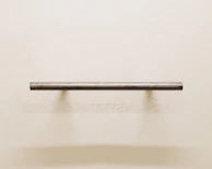 A delicate key hanger mounted on a charcoal grey wall, highlighting fine joinery.