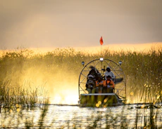 a couple of people on a boat in a body of water