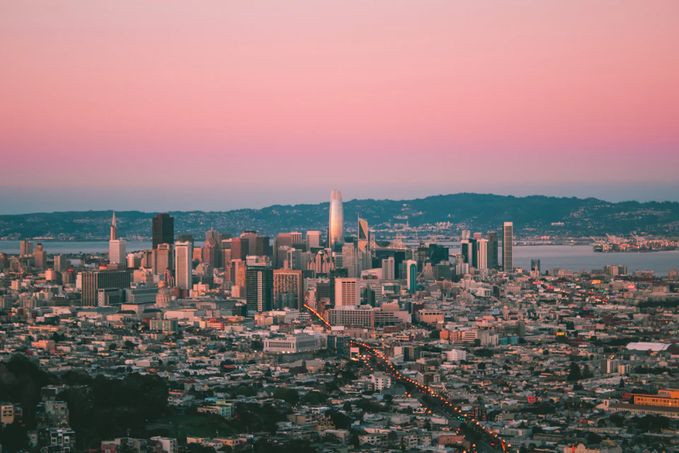 Panoramic view of San Francisco Bay Area at sunset with skyscrapers and cars