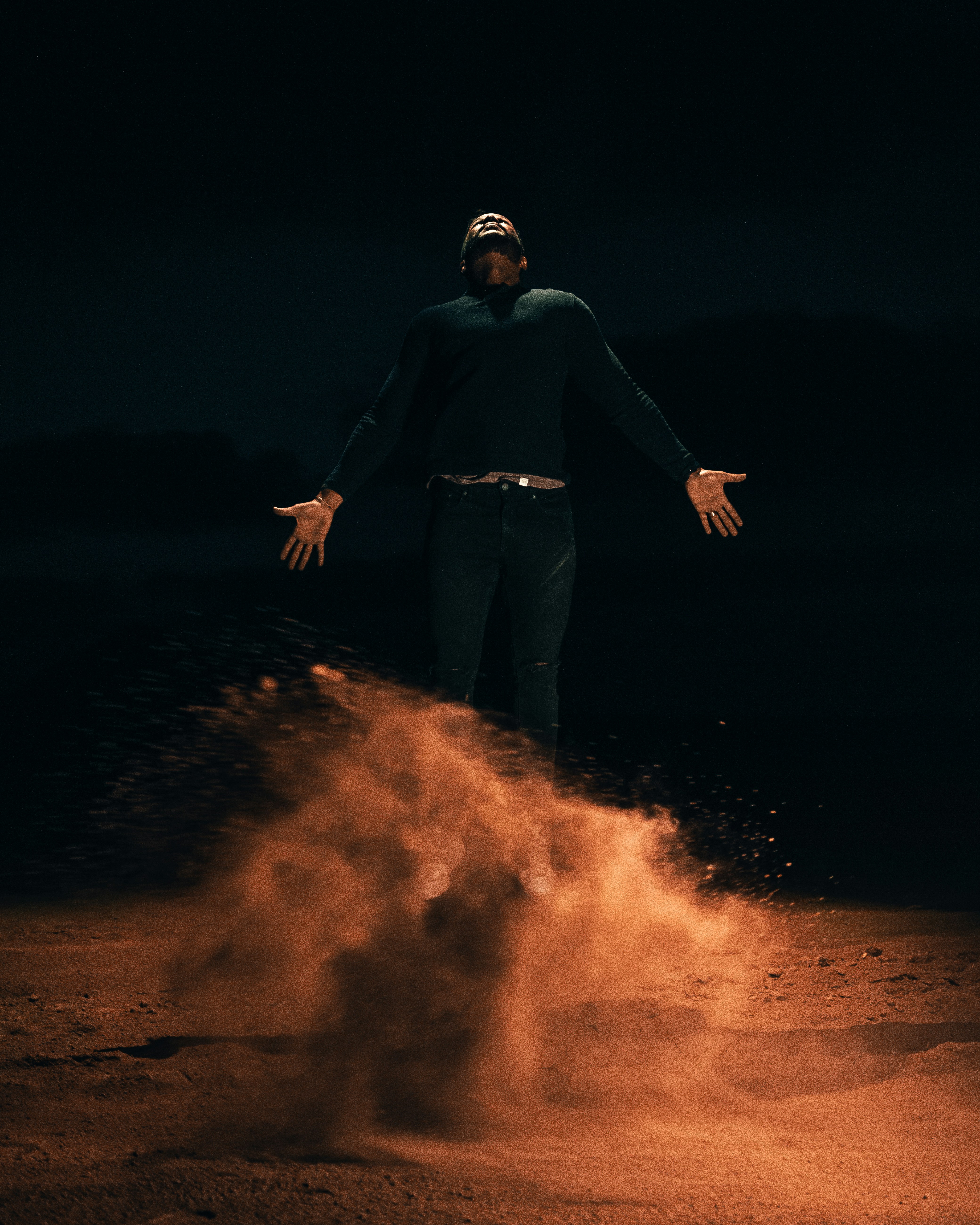 a man standing on top of a dirt field