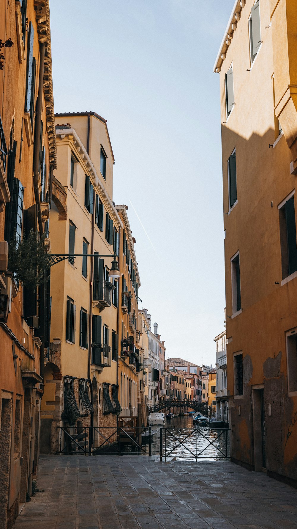 a narrow city street with buildings on both sides