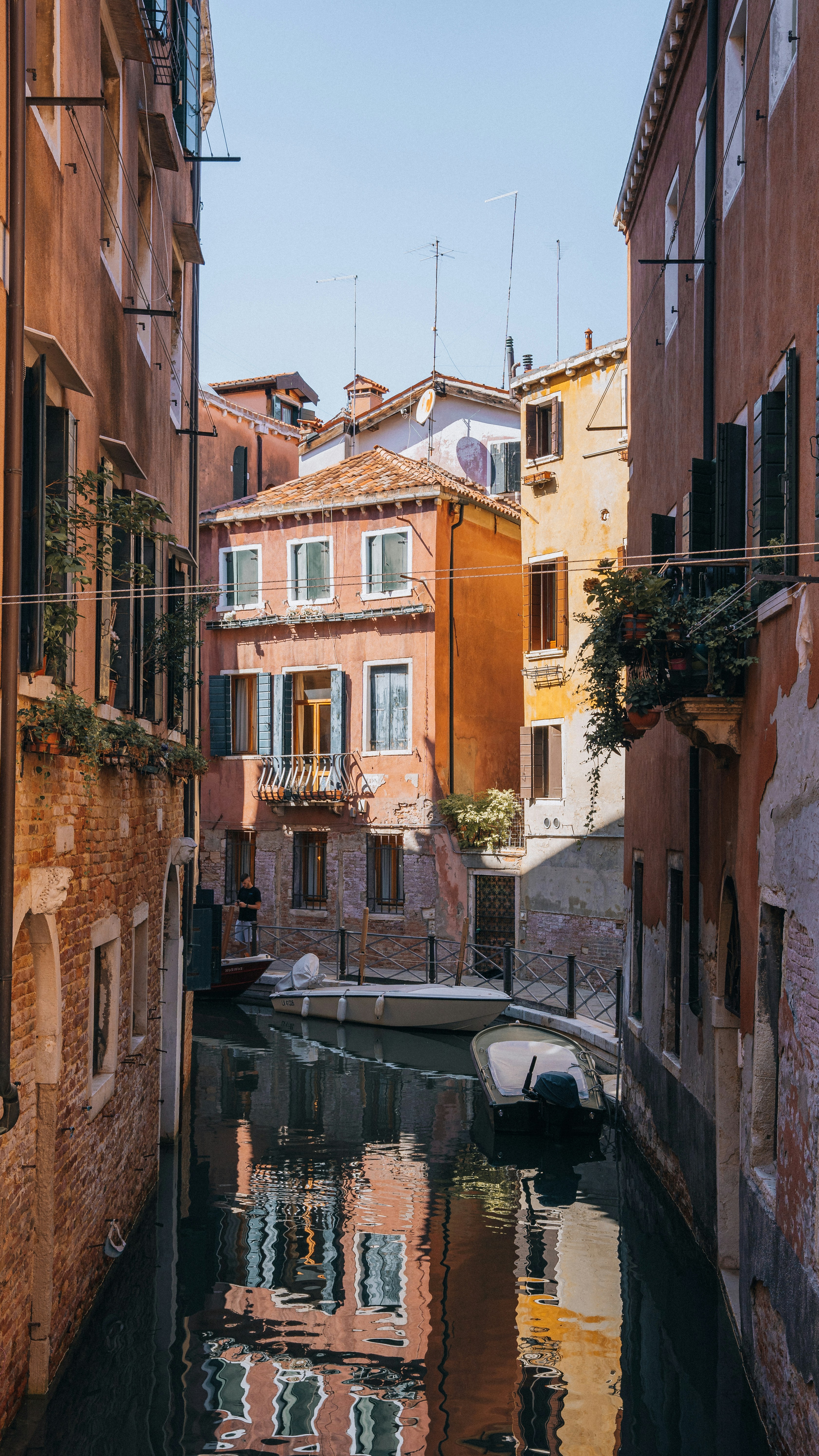 a narrow canal runs between two buildings in a city